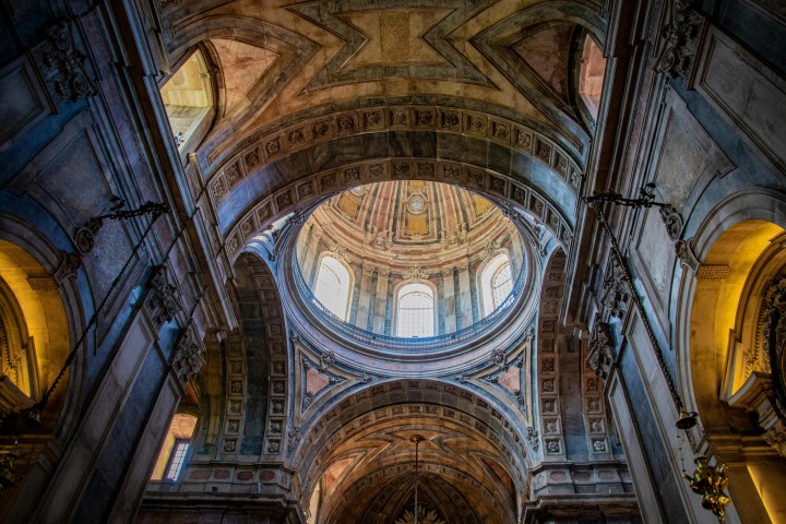 Interior view of a grand cathedral dome with intricate architectural details.